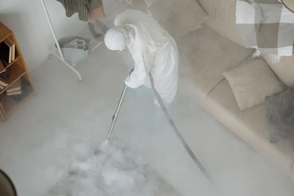 Biohazard cleanup technician in protective equipment, Marcus, IA